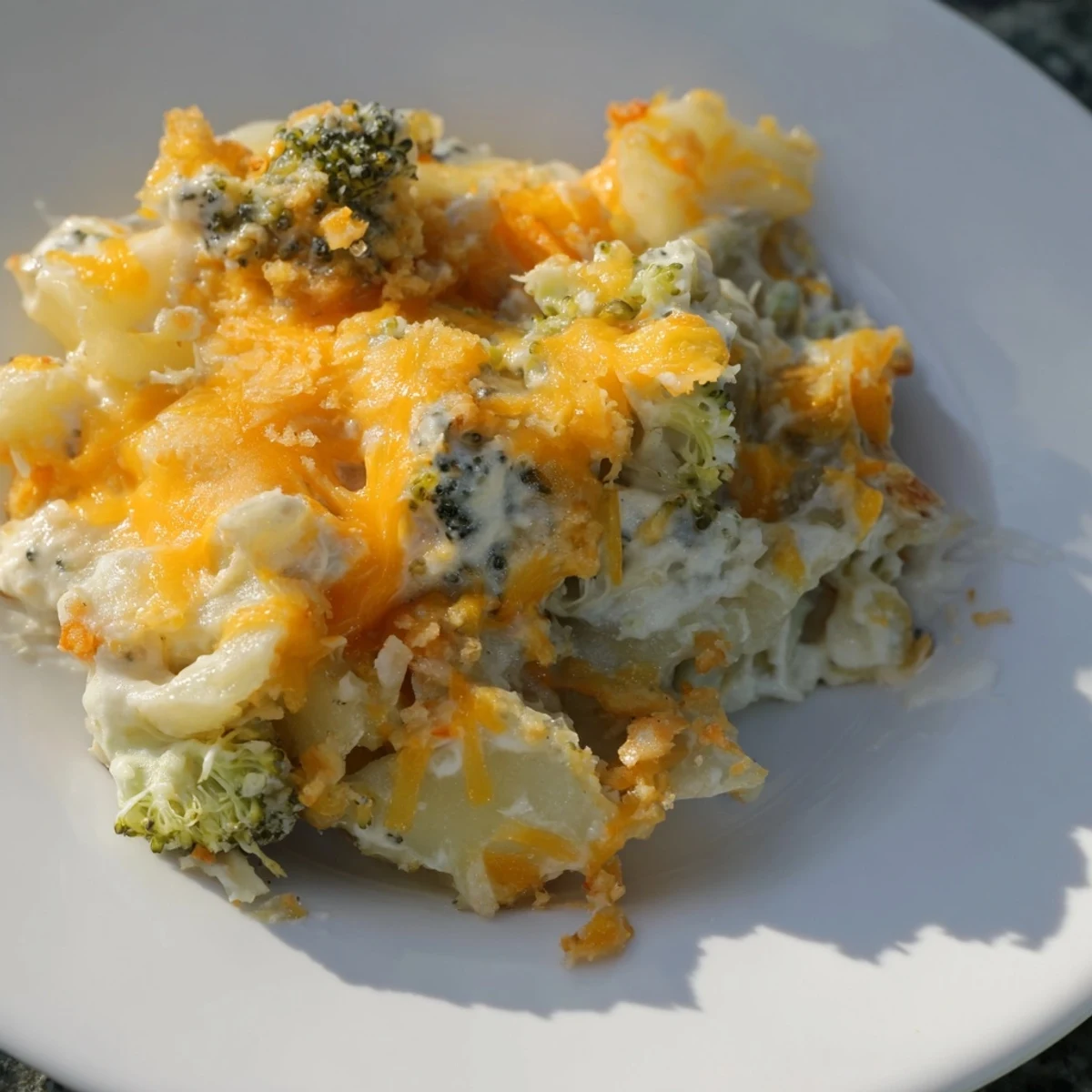 This Cheesy Potato and Broccoli Casserole shows off a creamy texture with a melted cheese topping.