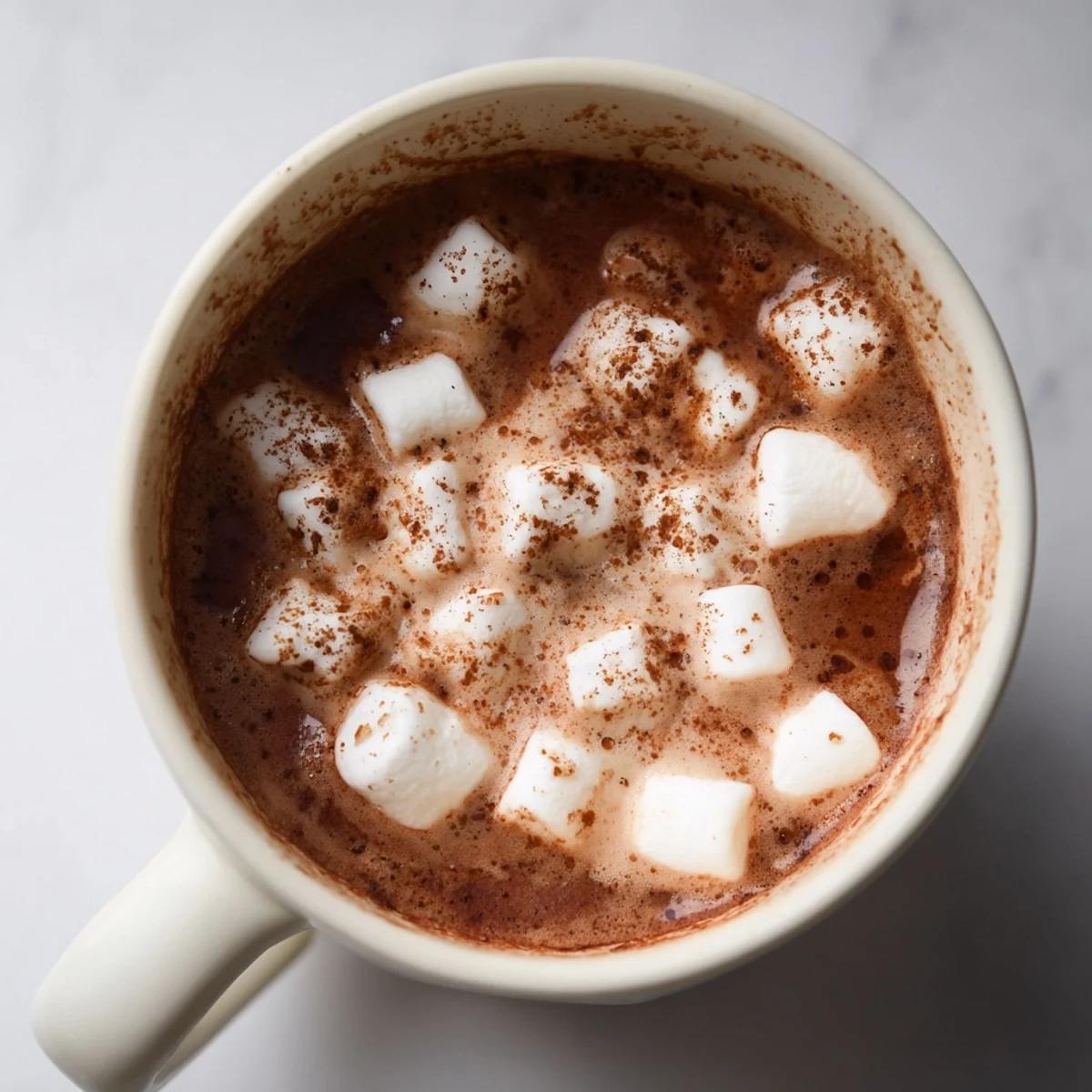 Enjoy the warmth: homemade Spiced Hot Chocolate swirled with spices and a cloud of marshmallows.