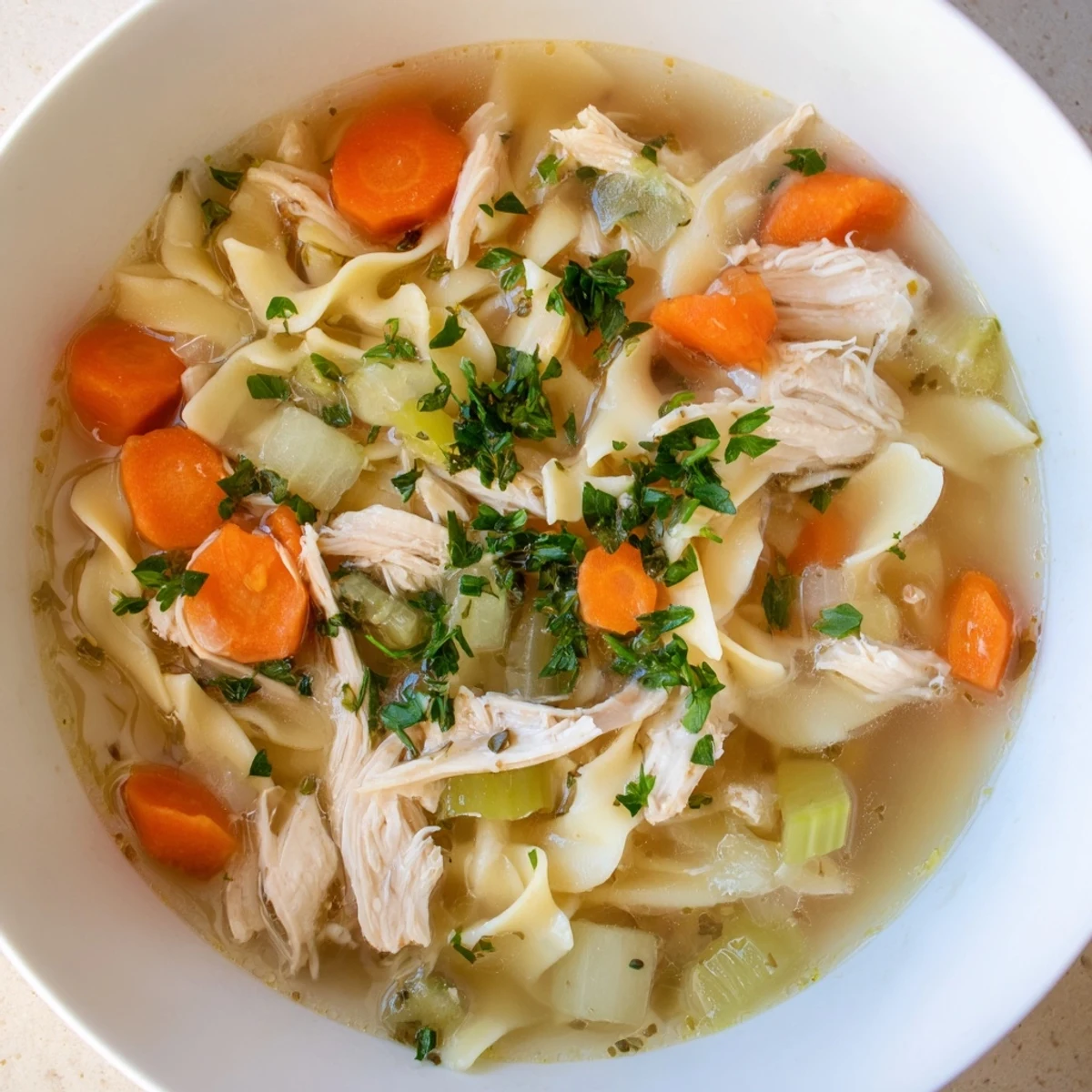 A simmering pot of homemade Savory Chicken Noodle Soup, the perfect remedy for a chilly day.