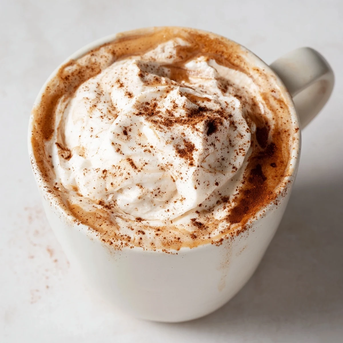 A warm mug of Gingerbread Spiced Latte, boasting rich, brown hues and inviting aromas.