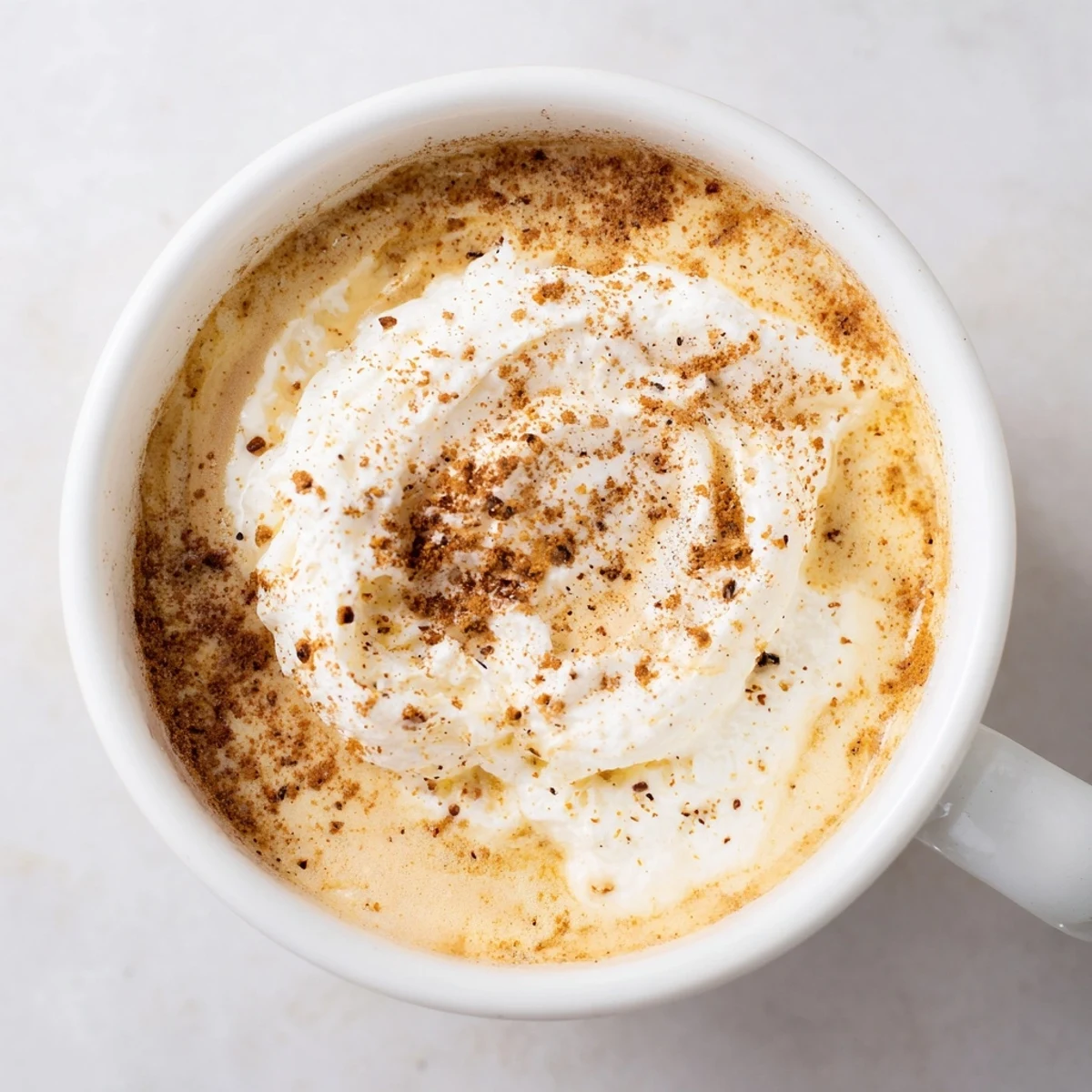 Indulge in a rich and flavorful Spiced Latte, topped with creamy foam and a dusting of nutmeg.
