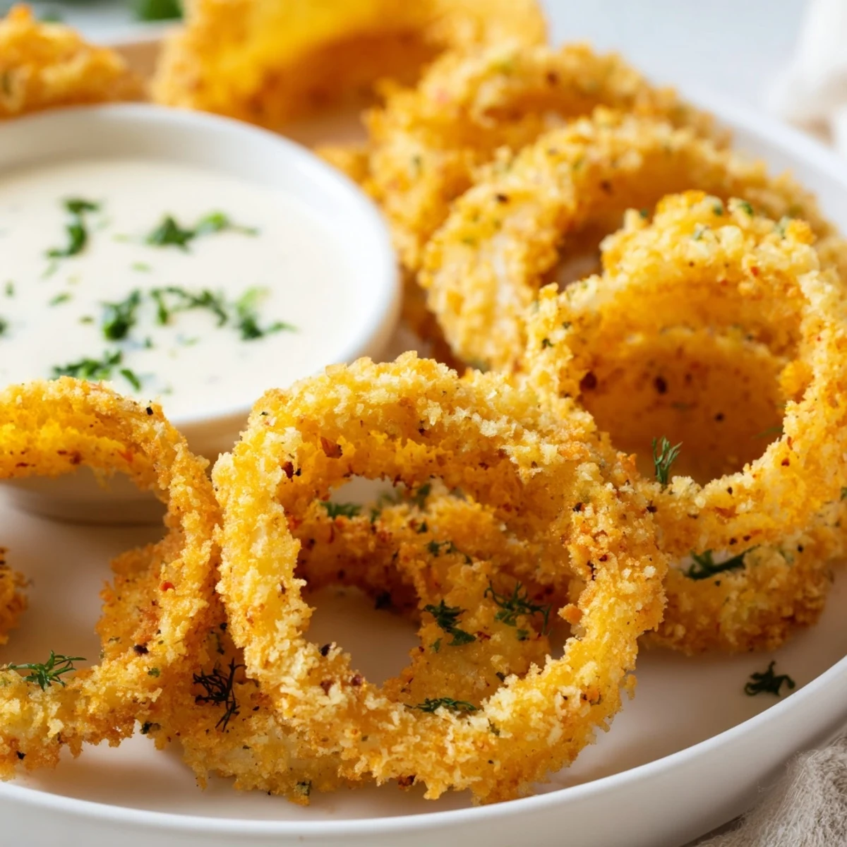 A close-up of delicious baked onion rings, showing their perfect golden-brown crust and texture.