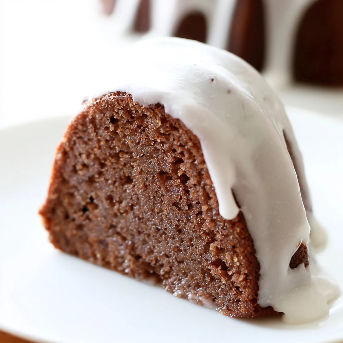 Freshly glazed Gingerbread Spiced Bundt Cake with warm spices, glistening on a cooling rack.