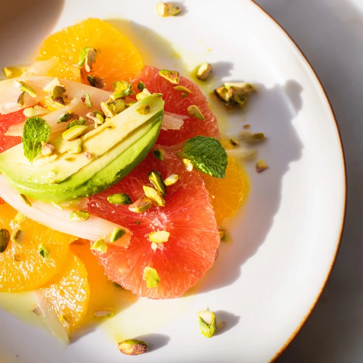 Colorful Winter Citrus Salad with Fennel and Avocado served on a white plate, ready to brighten winter days with fresh Mediterranean flavors.