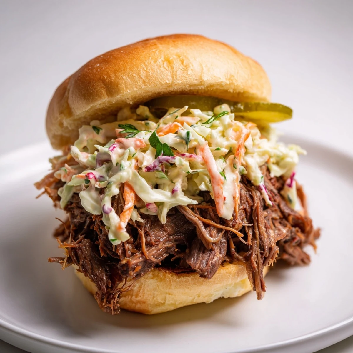 Slow Cooked Beef Brisket Sliders piled high with tender, smoky shredded meat on soft buns.