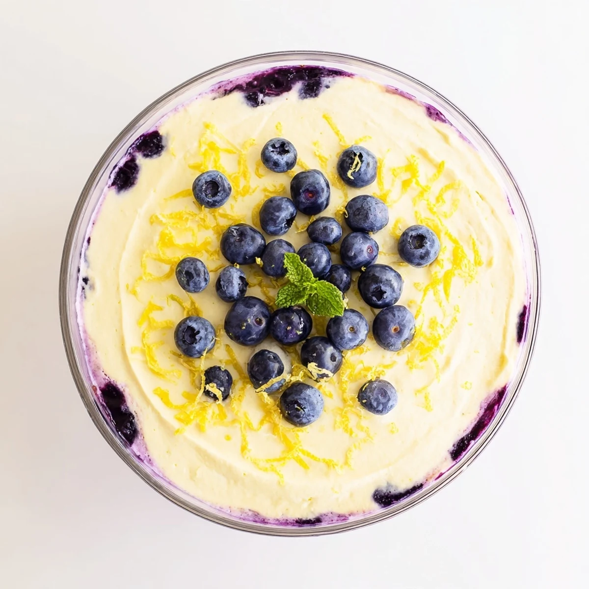 Spoonable Lemon Blueberry Mousse topped with zest and whipped cream, elegant gluten-free vegetarian dessert
