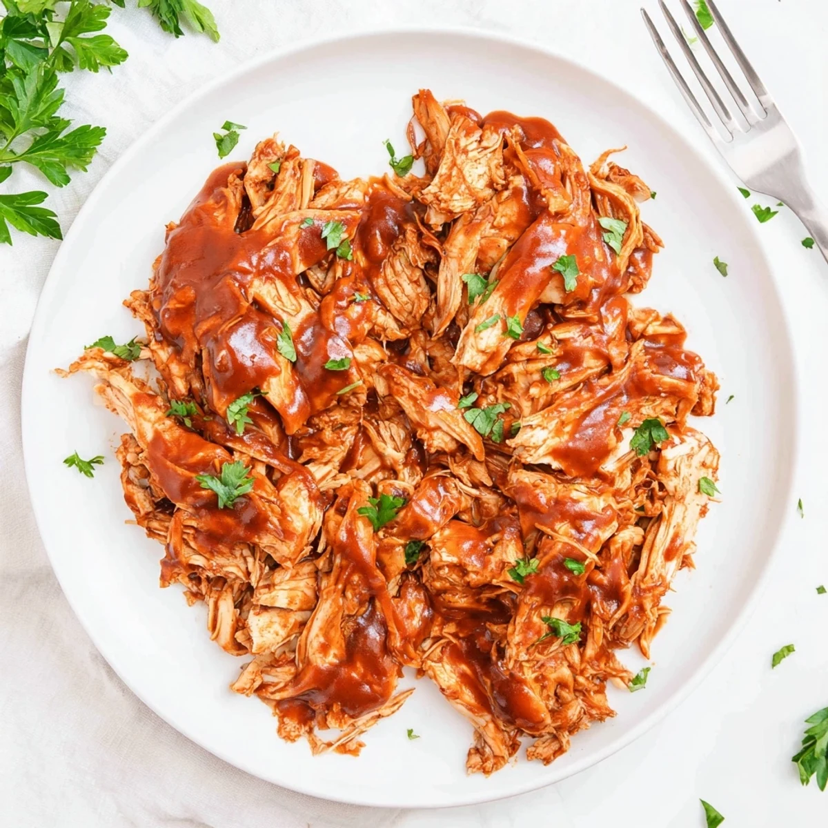 Slow-cooked tender chicken coated in Sweet Baby Rays barbecue sauce in a crockpot.