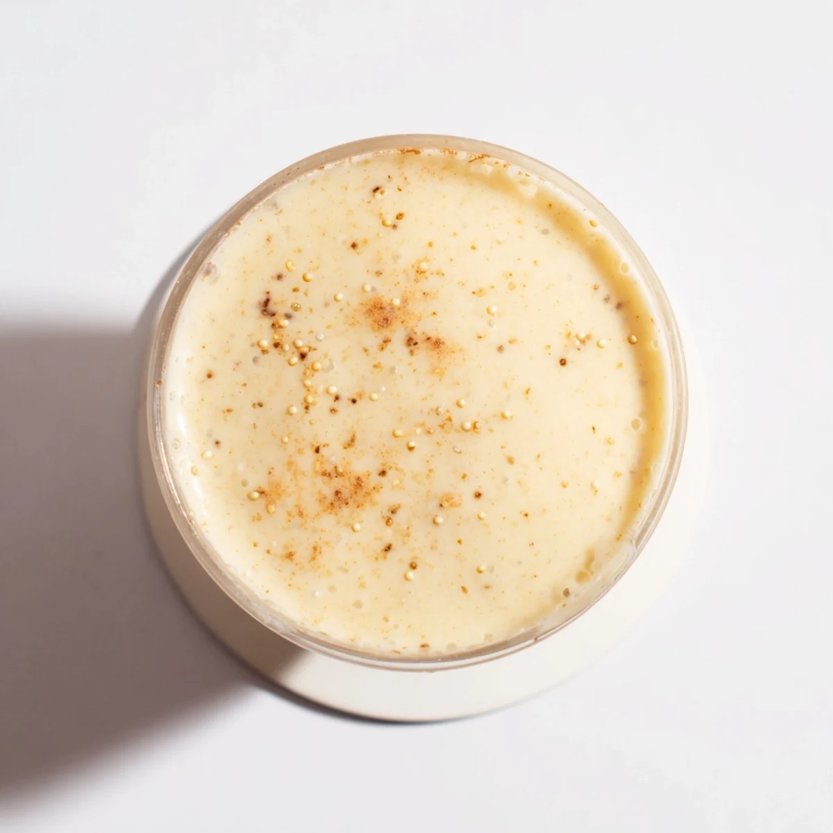 Thick and frothy Greek yogurt banana smoothie blended with ice and drizzled with honey