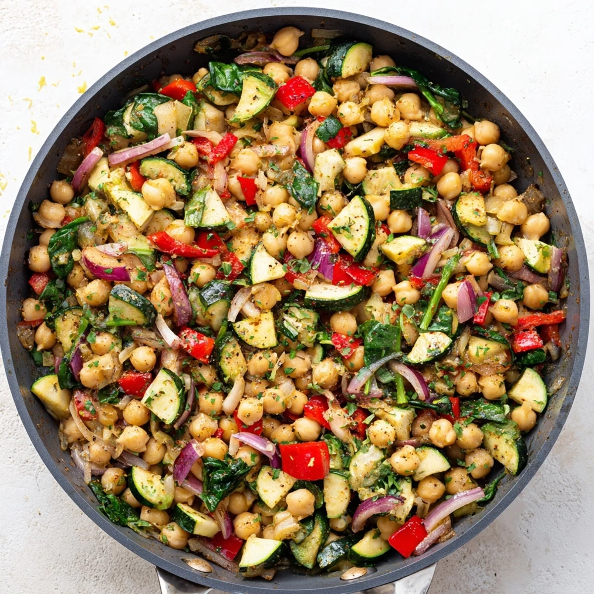 Golden chickpea lemon skillet with colorful vegetables in a cast iron pan