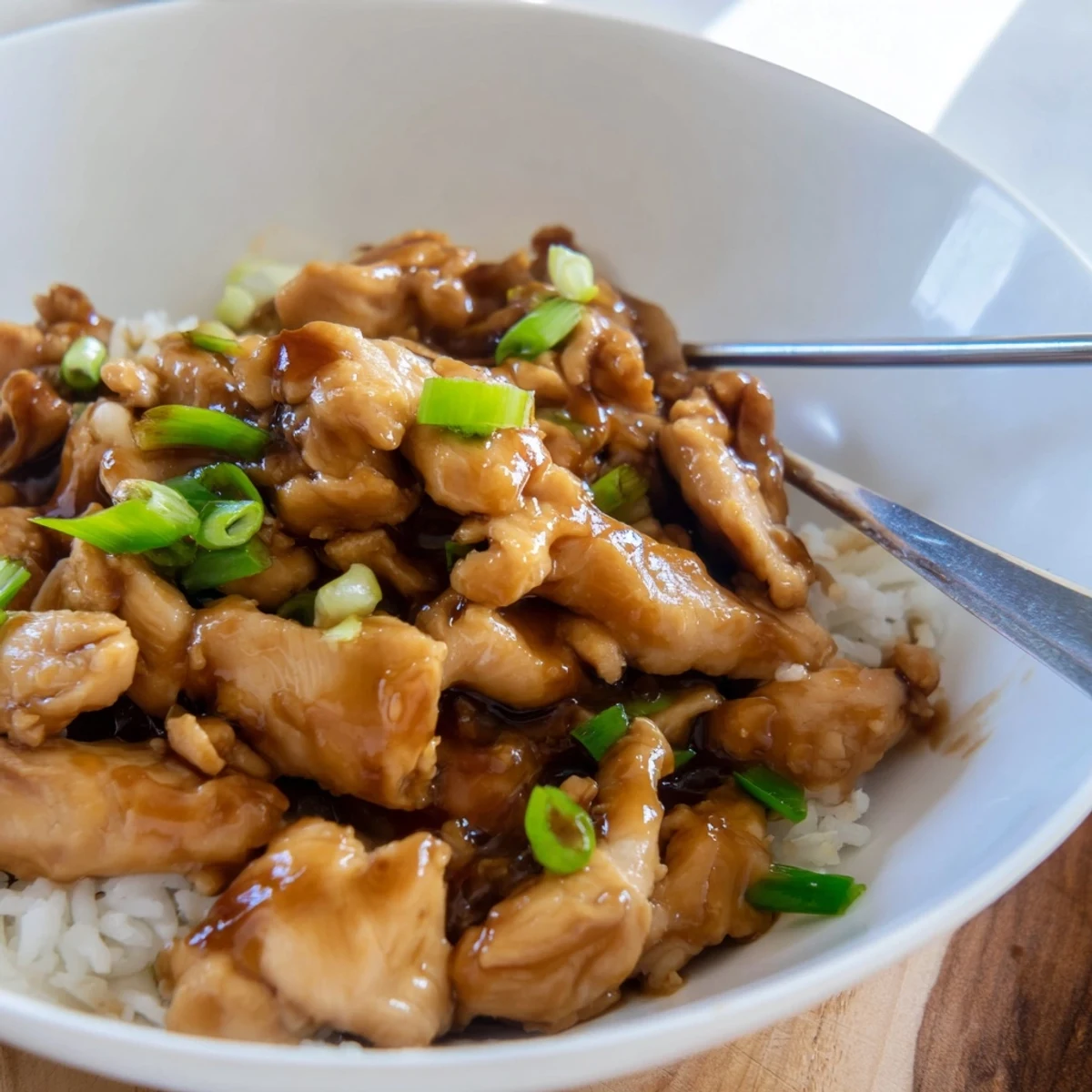 Golden brown Mongolian chicken pieces coated in a glossy sweet and savory garlic ginger sauce