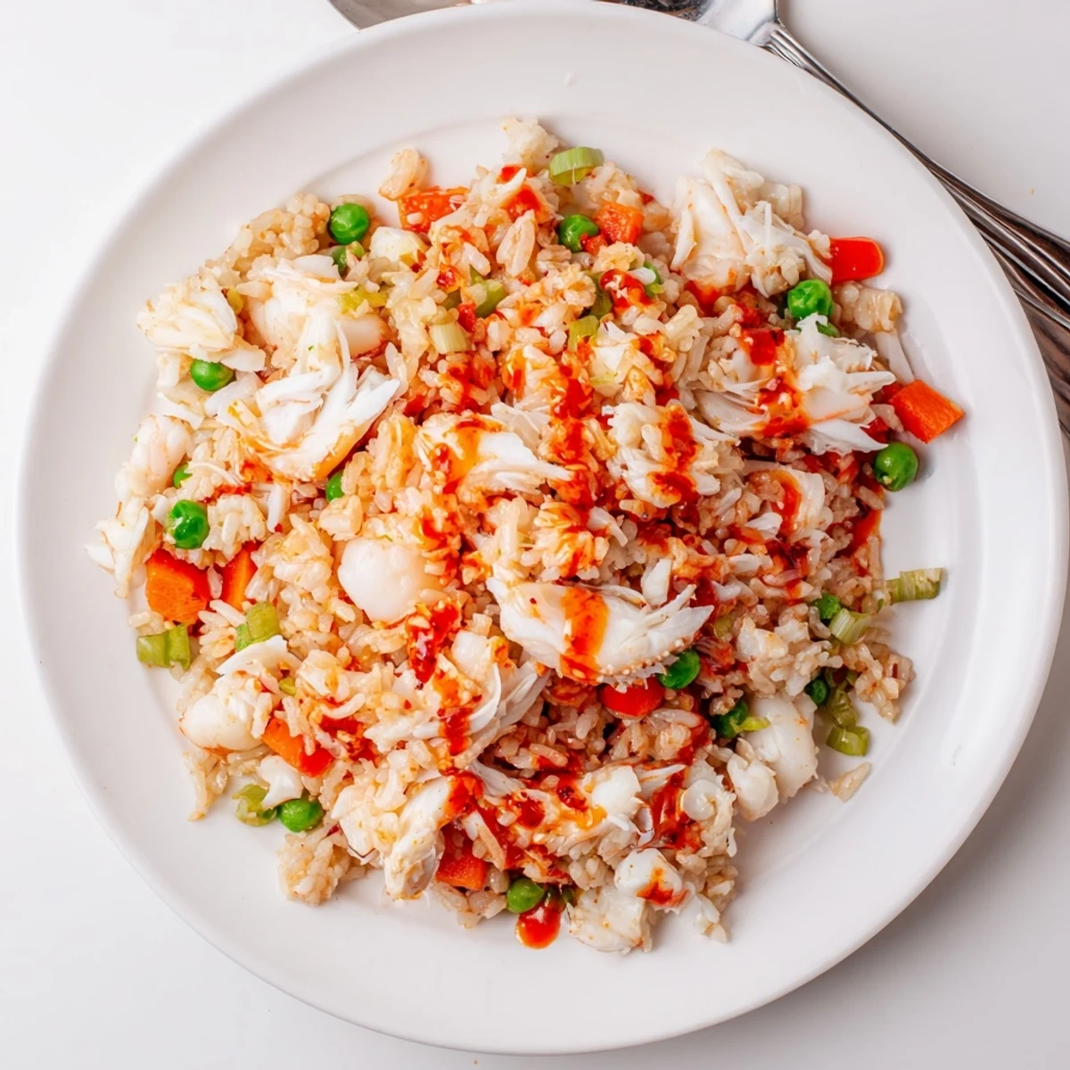 Close-up of spicy crab and shrimp fried rice showcasing tender seafood chunks and colorful vegetables coated in sauce