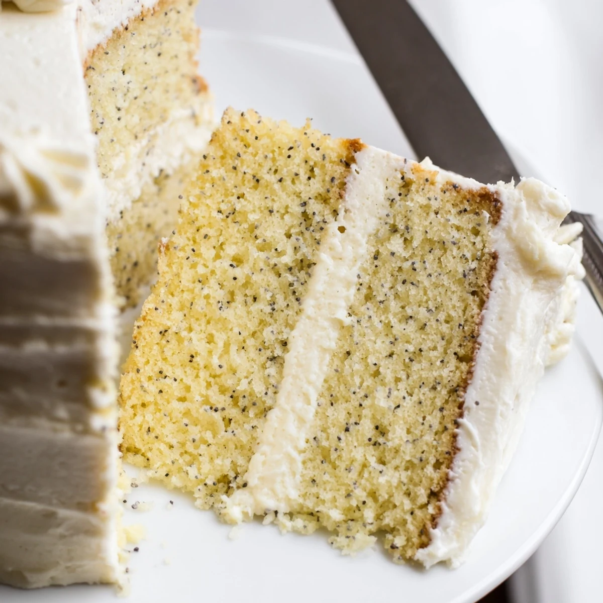 Classic vanilla bean birthday cake slice showing moist crumb and thick swirls of buttercream frosting