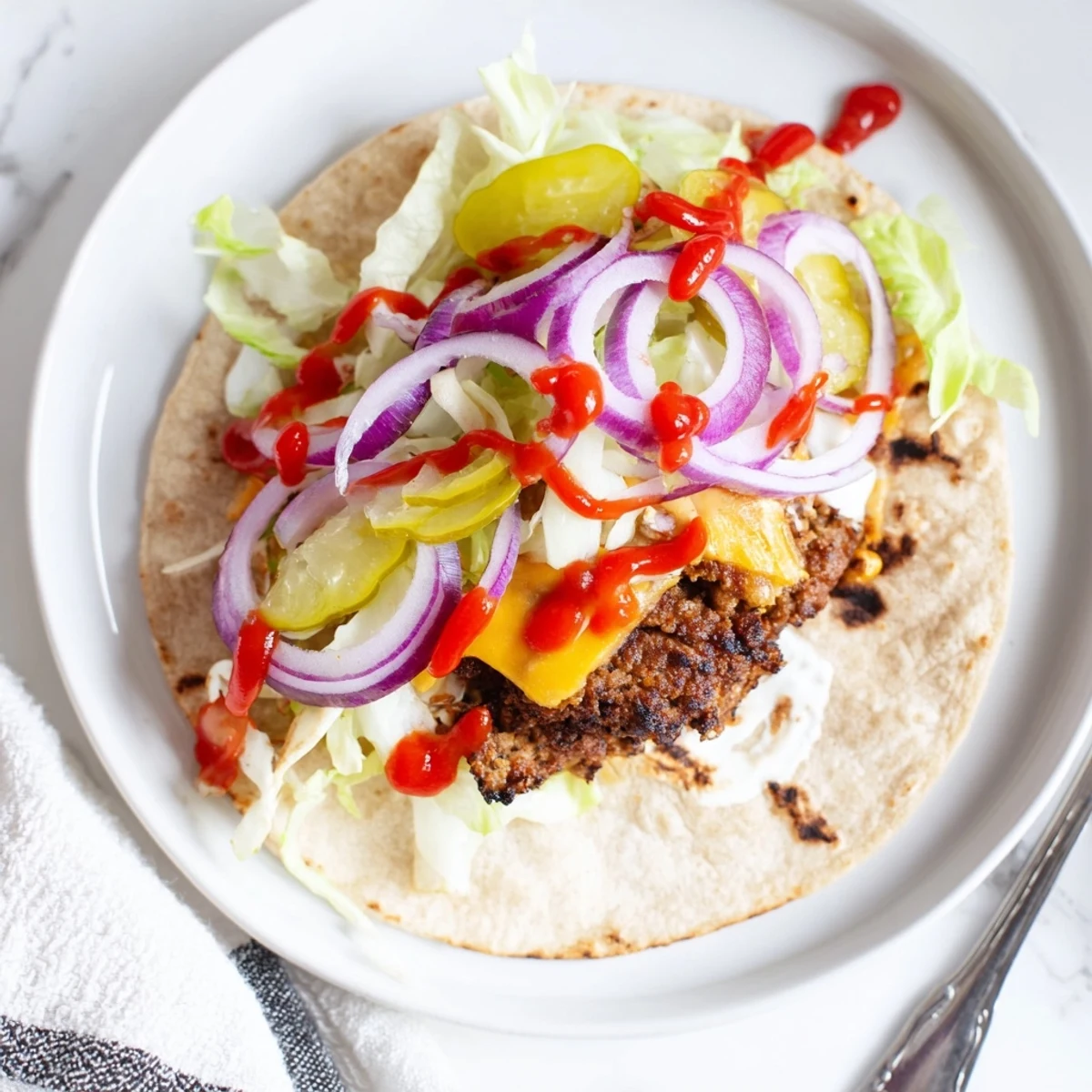 Hot Smash Burger Tacos Recipe served folded with crunchy lettuce, tangy pickles.