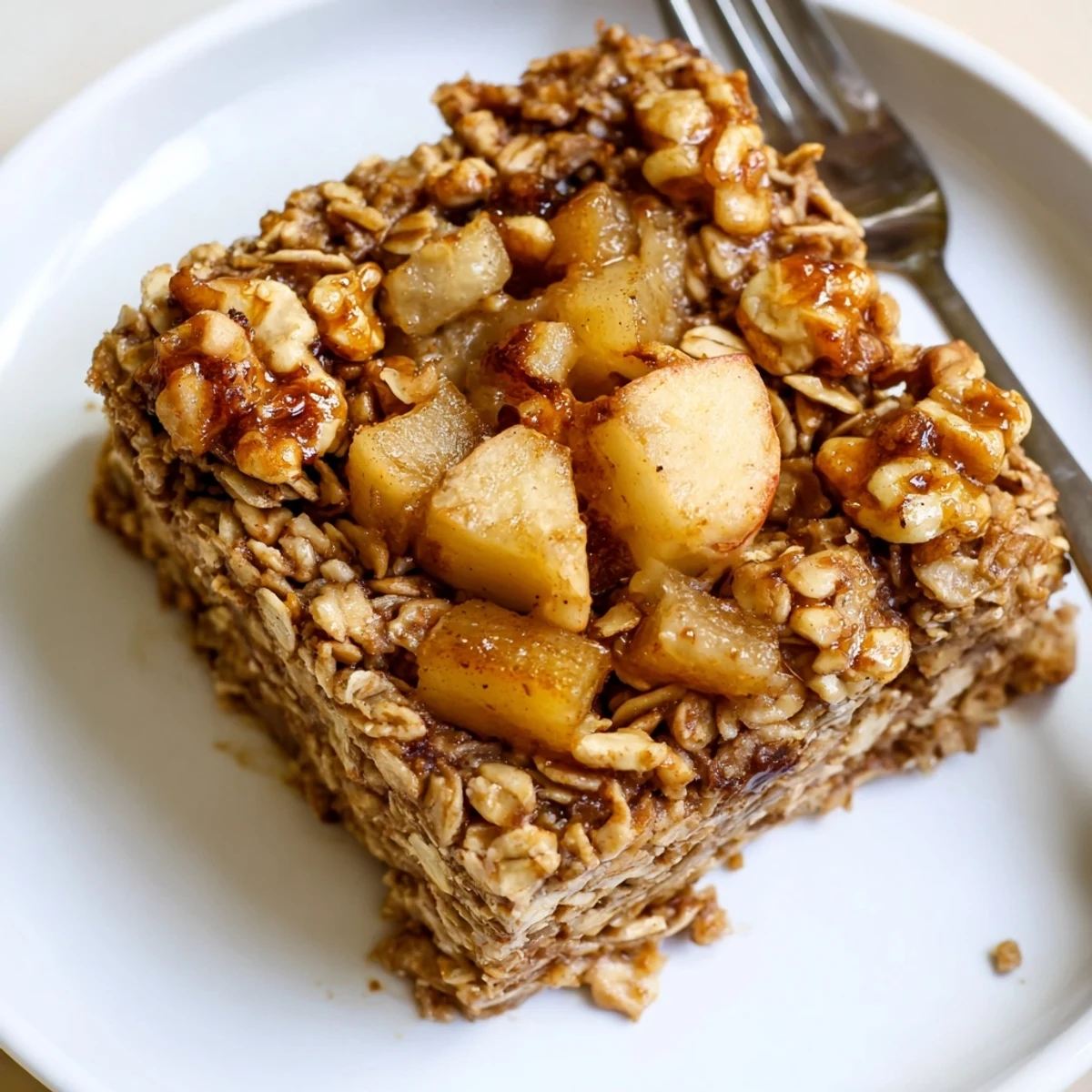Golden-crisp edges on Apple Cinnamon Oatmeal Bake, warm spice scent filling kitchen.