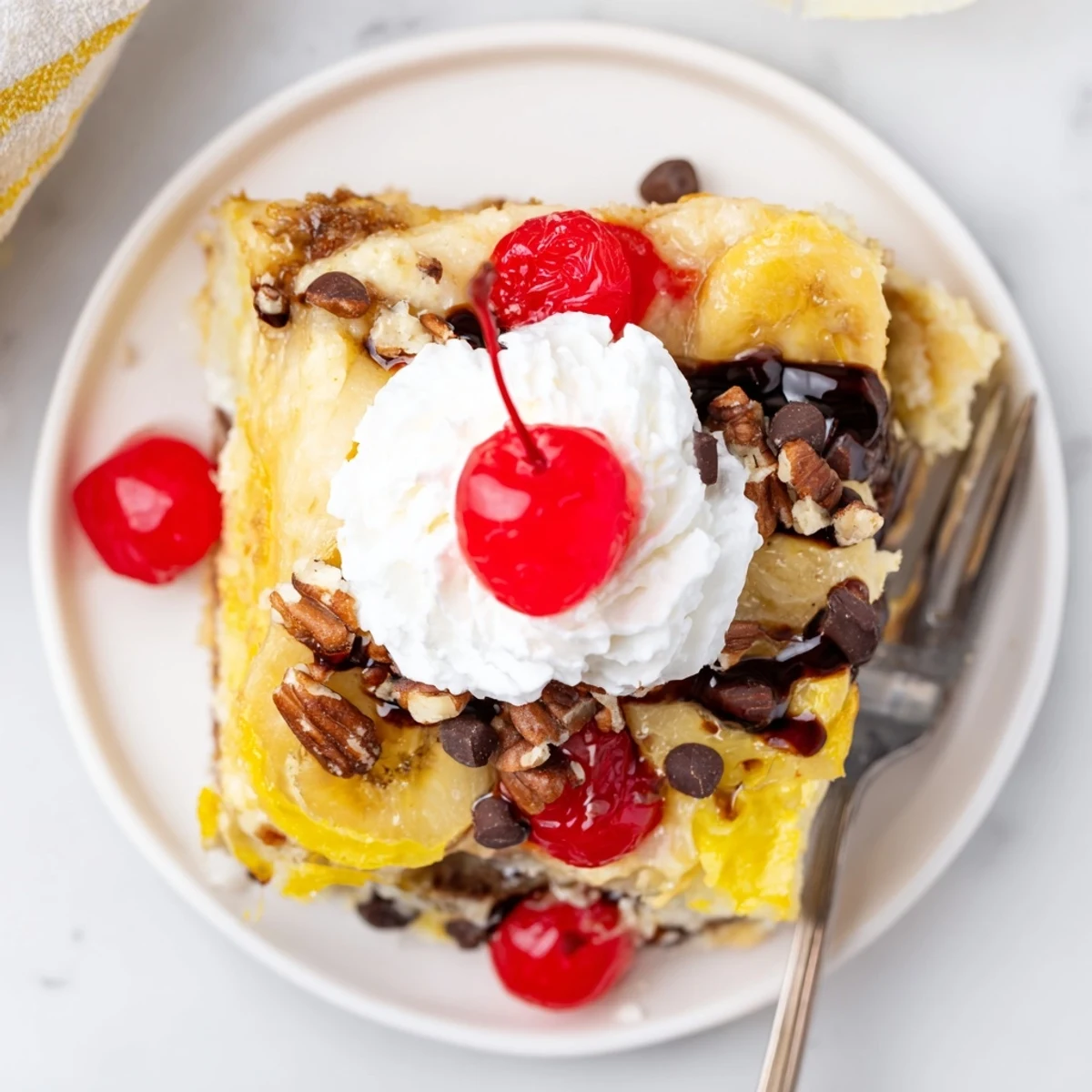 Comforting Banana Split Dump Cake served warm with a scoop of vanilla ice cream