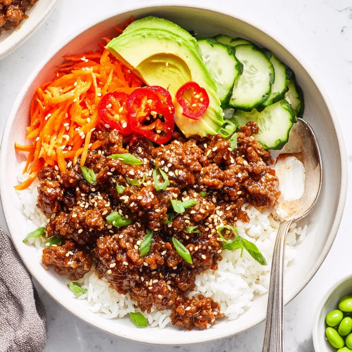 Steam rising from a Viral Ground Beef Hot Honey Bowl topped with sesame seeds