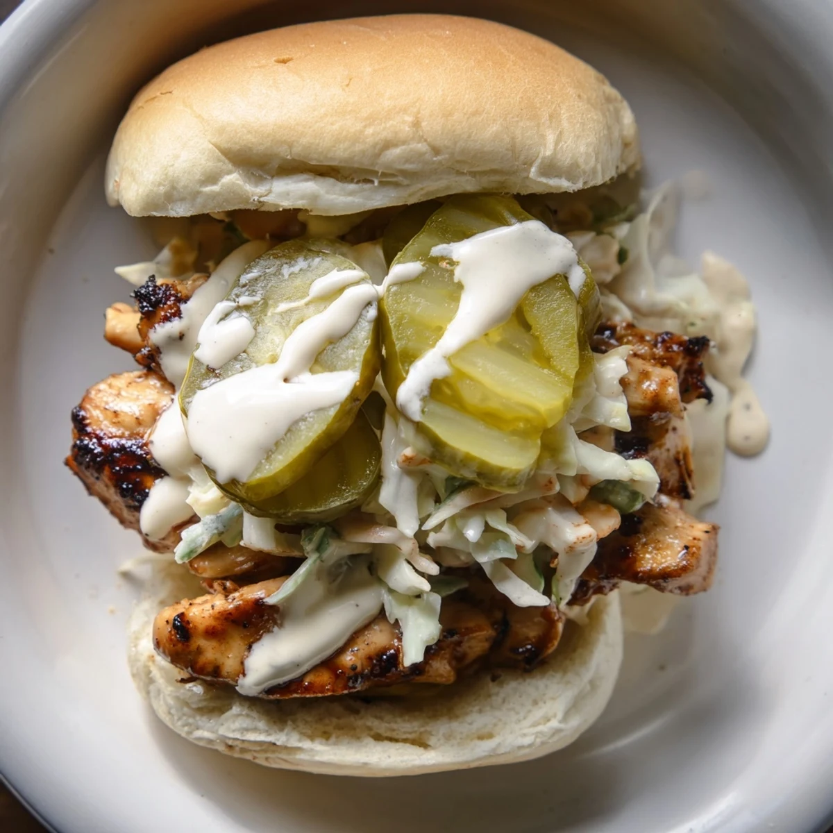 Southern-style Alabama BBQ Chicken Chopped Sandwich piled high with saucy chopped chicken, tangy pickles, and crunchy coleslaw