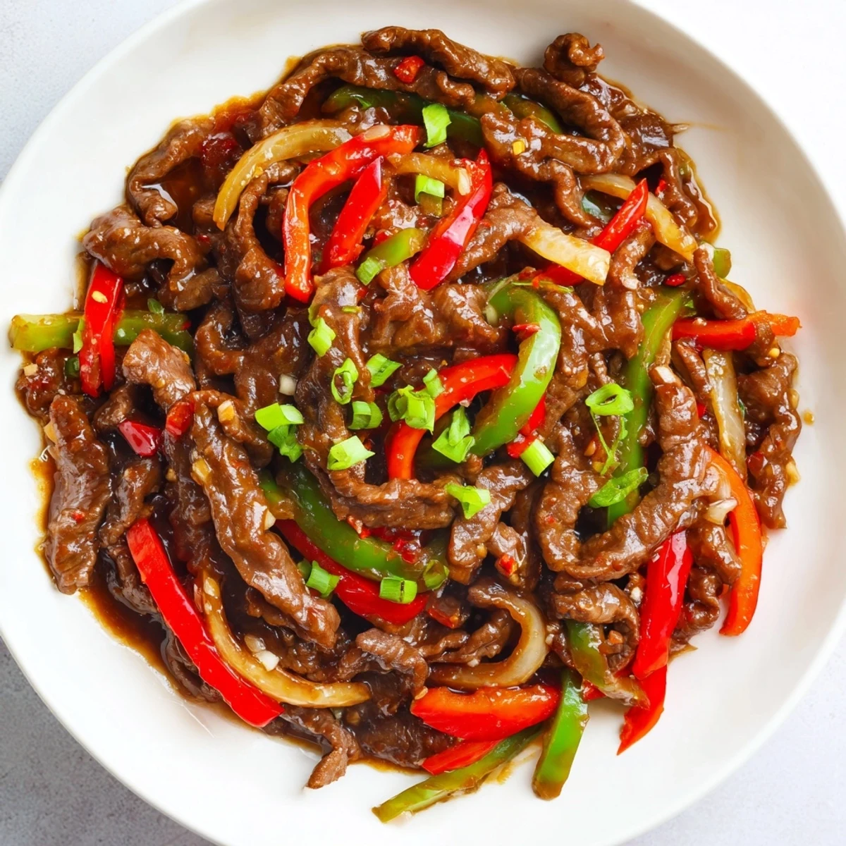 Sizzling wok filled with tender spicy beef stir fry colorful peppers and aromatic chili garlic