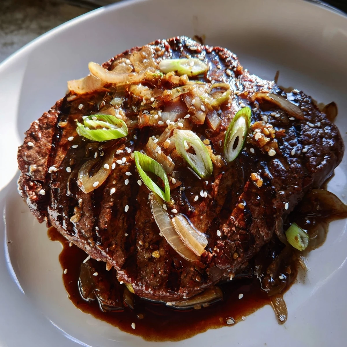 Tender Asian inspired cube steak glazed in rich soy sauce with colorful stir-fried vegetables