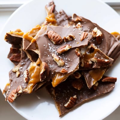 Pecan pie bark broken into rustic shards drizzled with melted semi-sweet chocolate